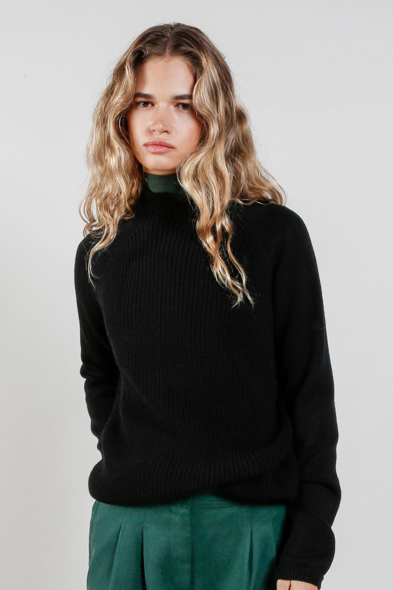  Model wears Womens black wool jumper. Wool, Black.